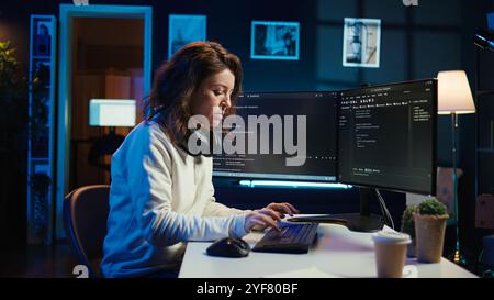 Teleworking computer technician typing on keyboard, implementing security measures to protect company systems and data, close up. Remote IT employee at home debugging code for software, camera B Stock Photo