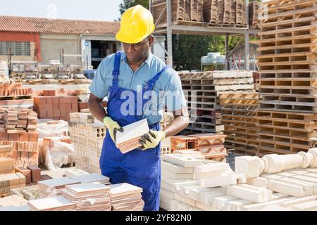 Builder is choosing ceramic tiles in building store Stock Photo