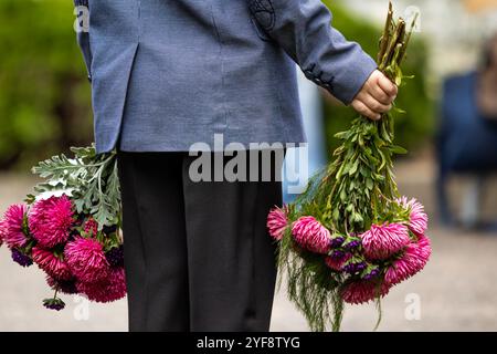 a boy with a bouquet goes to school on the first of September Stock Photo