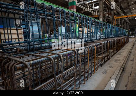 Steel rods or bars used to reinforce concrete, in warehouse at the metalworking shop. Modern industrial enterprise. Stock Photo