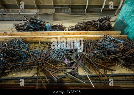 Steel rods or bars used to reinforce concrete, in warehouse at the metalworking shop. Modern industrial enterprise. Stock Photo