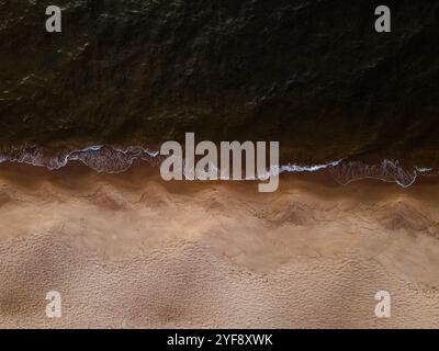 Aerial view of a beach with waves hitting the shore Stock Photo