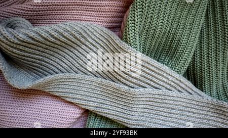 The background is filled with knitted fabric of different colors. Gray, turquoise, purple. Clothing. Gray diagonal stripe from above. Under it are tur Stock Photo