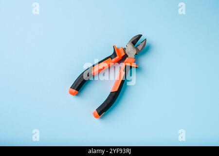 Top view of Nippers or diagonal cutting pliers on blue background Stock Photo