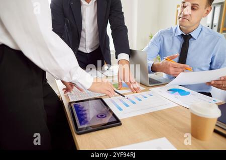 Business managers in the office checking company reports, close-up Stock Photo