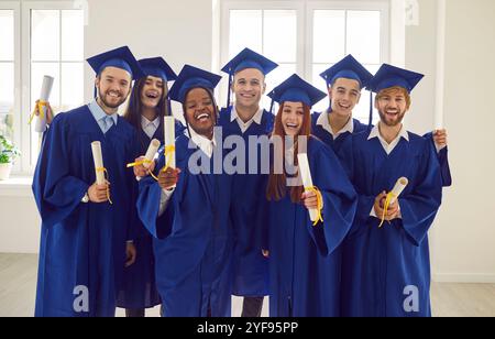 Multinational Graduating Class: Smiling Students with Diplomas Stock Photo