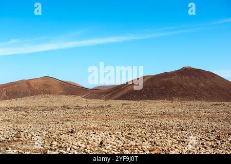 Spectacular landscape of Calderon Hondo volcano with rocky surface located in dry valley under blue sky on Fuerteventura island. Spain Stock Photo