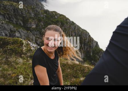 Portrait of cheerful young woman against mountain Stock Photo