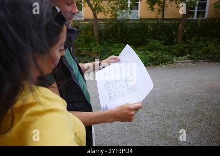High angle view of male and female architect examining blueprint of residential building Stock Photo