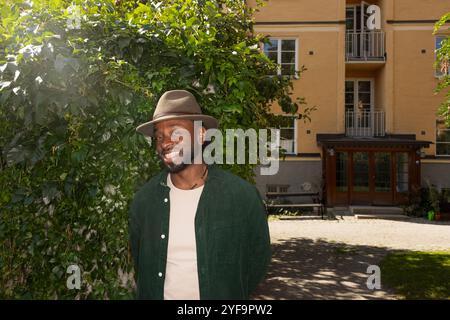 Portrait of smiling young man standing outside building Stock Photo