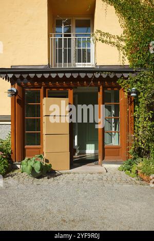 Stack of cardboard boxes at building entrance Stock Photo