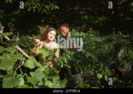Portrait smiling friends standing amidst plants Stock Photo