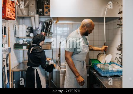 Two barista working in kitchen at coffee shop Stock Photo