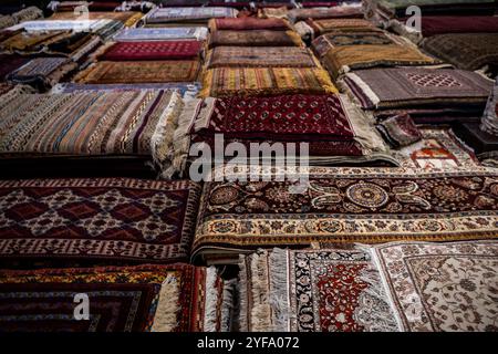 The wide range of the hand made carpets, traditional knotted Uzbek silk rugs in the small bazaar, Bukhara, Uzbekistan, Central Asia Stock Photo