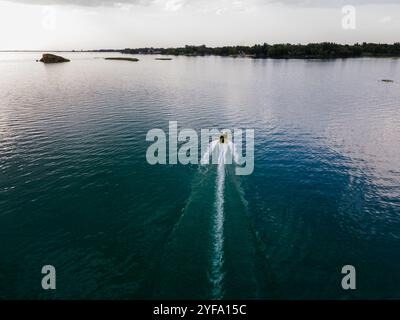 Aerial top view of a motor powerboat forming a circle of waves Stock ...