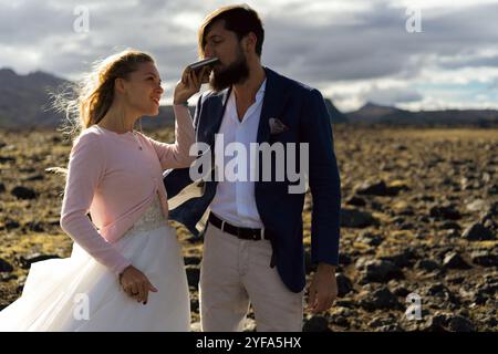 Couple in wedding suits in Iceland against the mountains Stock Photo