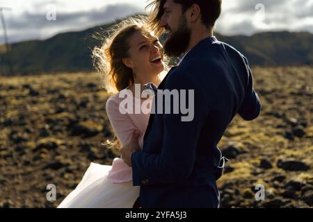 Couple in wedding suits in Iceland against the mountains Stock Photo