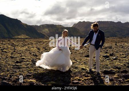 Couple in wedding suits in Iceland against the mountains Stock Photo