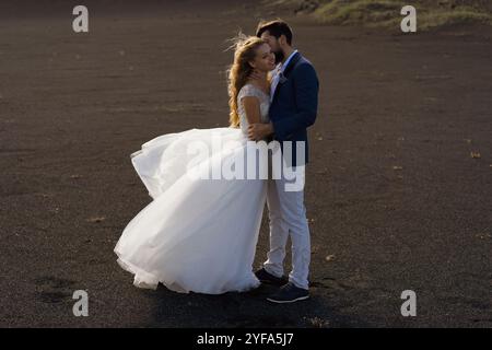 Couple in wedding suits in Iceland against the mountains Stock Photo