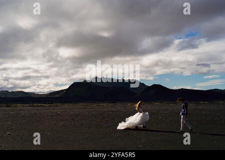 Couple in wedding suits in Iceland against the mountains Stock Photo