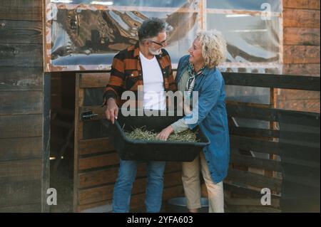 A middle-aged couple exchanging glances while preparing the food Stock Photo