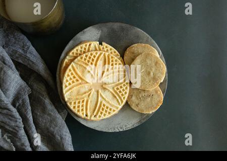 decorative cookies on a stoneware plate with gray linen napkin Stock Photo