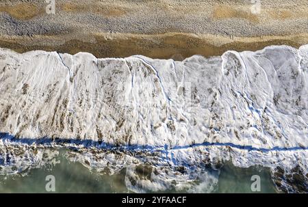 Aerial view of stormy ocean waves breaking on a sandy beach. Nature background Stock Photo