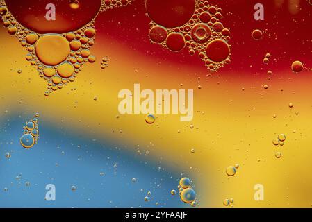 Abstract, image of oil, water and soap in a glass bowl with colourful background Stock Photo
