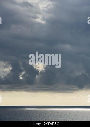 Stormy clouds with dramatic sky above the ocean at sunset Stock Photo