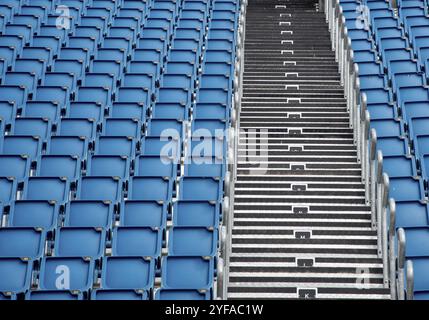 Blue plastic empty stadium or stage chairs in a row Stock Photo