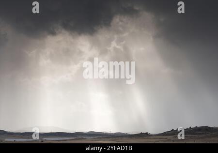 Sun rays between dramatic stormy clouds before the storm Stock Photo