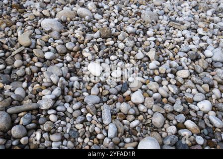 Beautiful and colourful sea pebbles on the beach creating a beautiful nature background Stock Photo