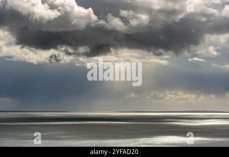 Stormy sky with dramatic clouds above the sea. Stormy weather at the ocean Stock Photo