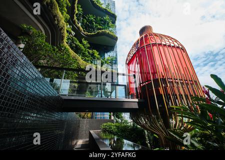 Singapore - August 16, 2024: Park Royal Collection Pickering Hotel infinity pool with tropical plants and colorful lodges Stock Photo