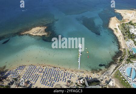 Aerial drone photograph of fig tree bay beach. with tourists relaxing and enjoying summer vacations cyprus Stock Photo