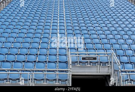 Blue plastic empty stadium or stage chairs in a row Stock Photo