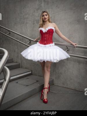 Ballerina wearing high heels and christmas dress posing outdoors. Dancing outdoor Stock Photo
