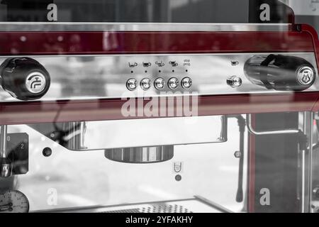 Professional black coffee machine stands on a desk in a cafeteria. Coffee machine close up. Espresso coffee maker close-up. Modern Industrial coffee m Stock Photo