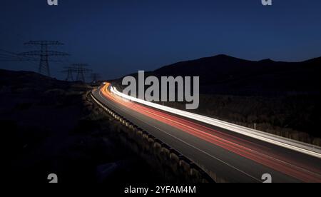 Light trails from cars moving fast late in the evening. Concept of high speed Stock Photo