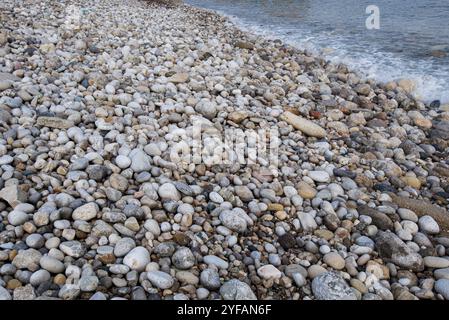 Beautiful and colourful sea pebbles on the beach creating a beautiful nature background Stock Photo