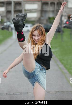 cute cheerful teenage girl kicking her leg uo outdoors Stock Photo