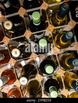 Rows of red and white wine in a modern wooden rack Stock Photo