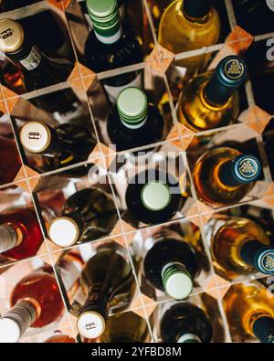 Rows of red and white wine in a modern wooden rack Stock Photo