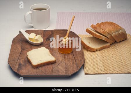 A healthy food a bread toast with butter and pure organic honey from bees on the wooden table board. High quality photo Stock Photo