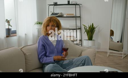 African girl freelancer american biracial woman lying on couch at home ...