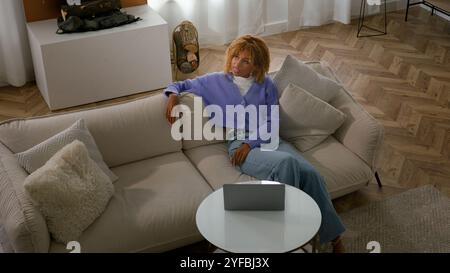 African girl freelancer american biracial woman lying on couch at home ...