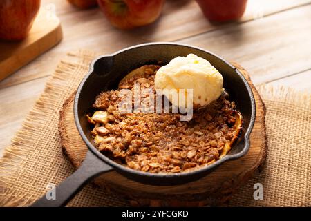 Apple oat crumble, walnuts, butter and brown sugar with vanilla ice cream topping, homemade recipe, traditional dessert perfect for the winter season Stock Photo