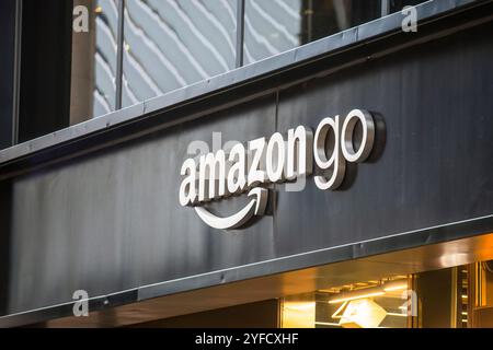 A close-up of an Amazon Go store sign on a black storefront in an urban setting, featuring modern branding and reflecting the concept of cashierless. Stock Photo