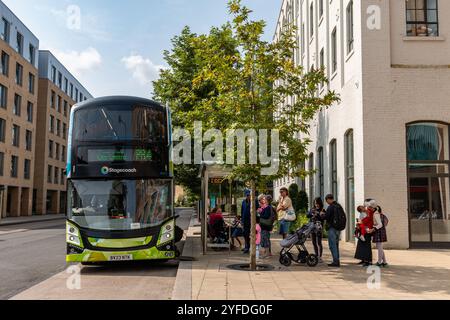 A queue of people are waiting to board the Park and Ride double decker bus from Trumpington to Cambridge town centre. England, UK Stock Photo