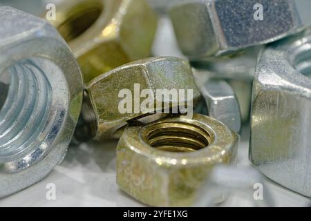 Assorted galvanized hex nuts of various sizes, close up shot. Stock Photo